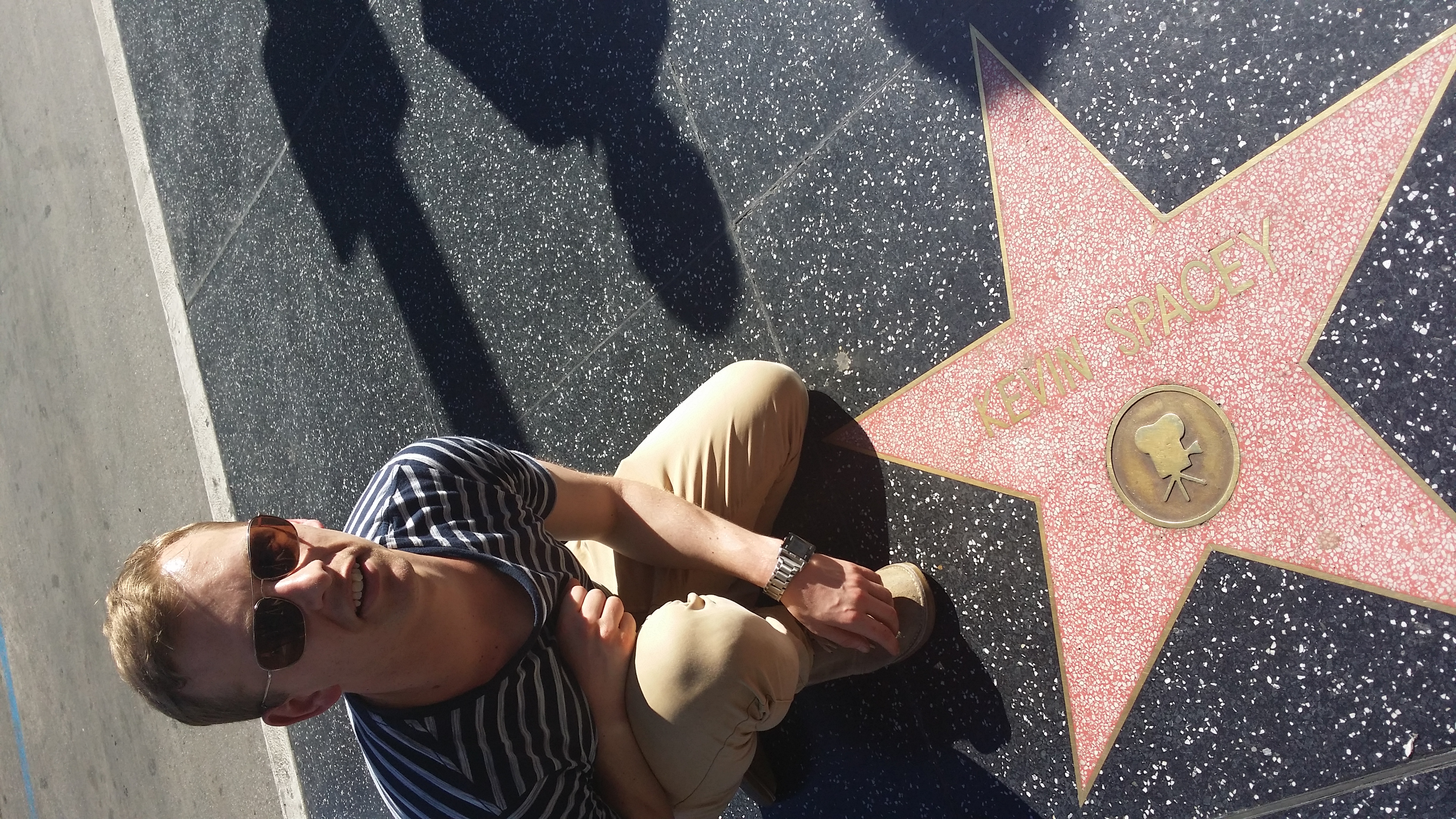 A photo of Johnny crouching by Kevin Spacey's star on the Hollywood walk of fame.